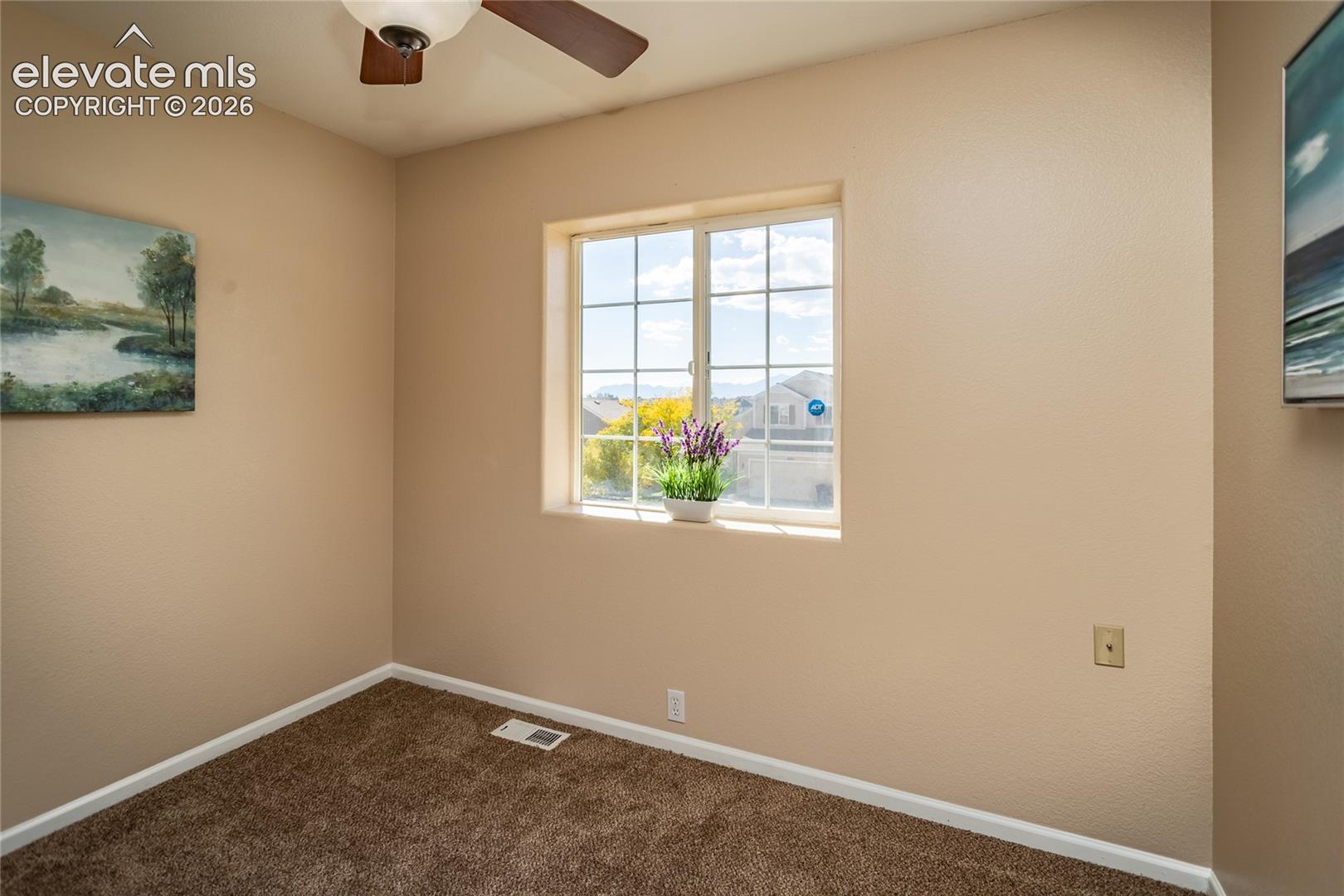  Large windows in this bedroom capture views toward the nearby mountain peak and fall foliage