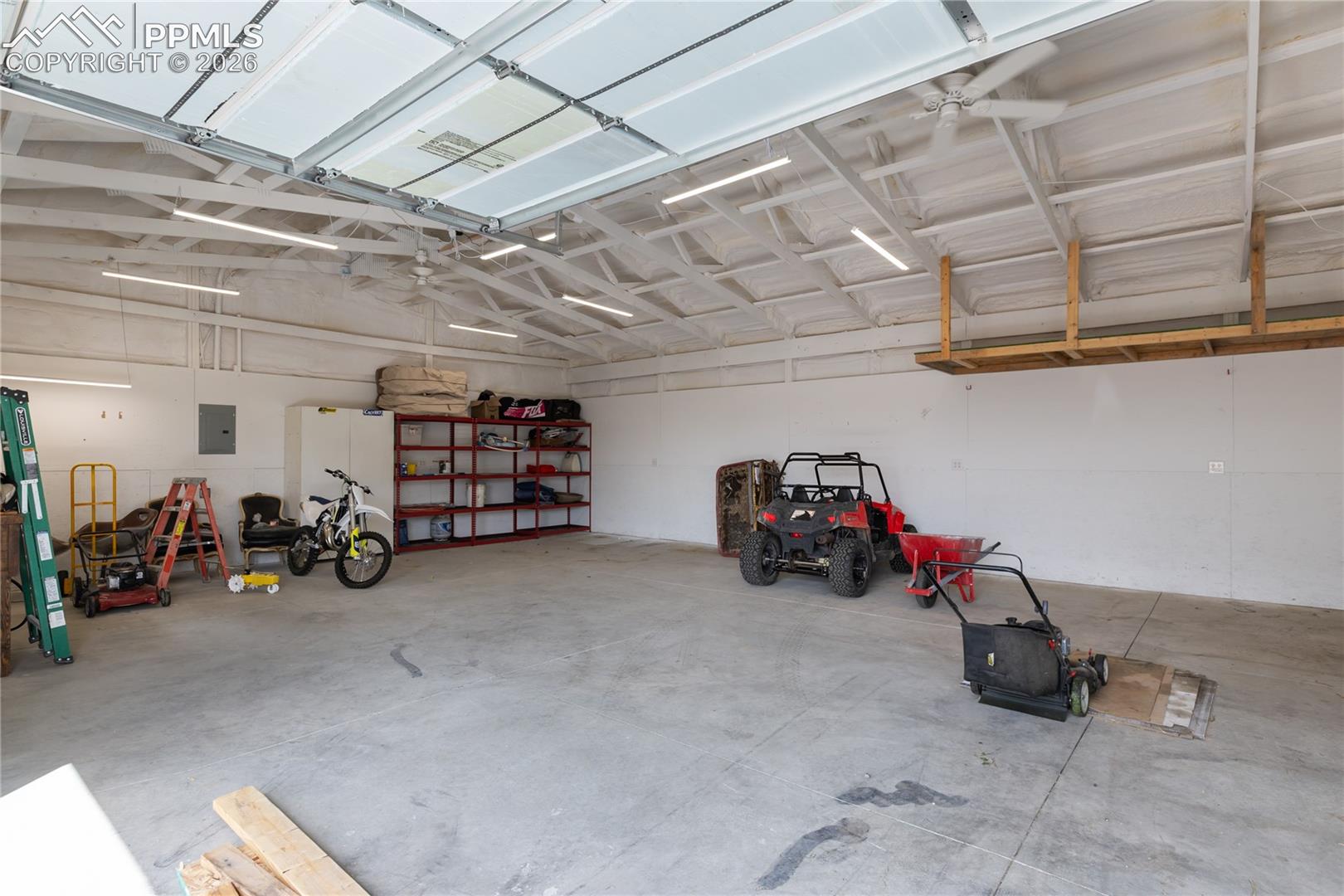 Spacious insulated shop with high ceilings and room for vehicles, storage, or projects