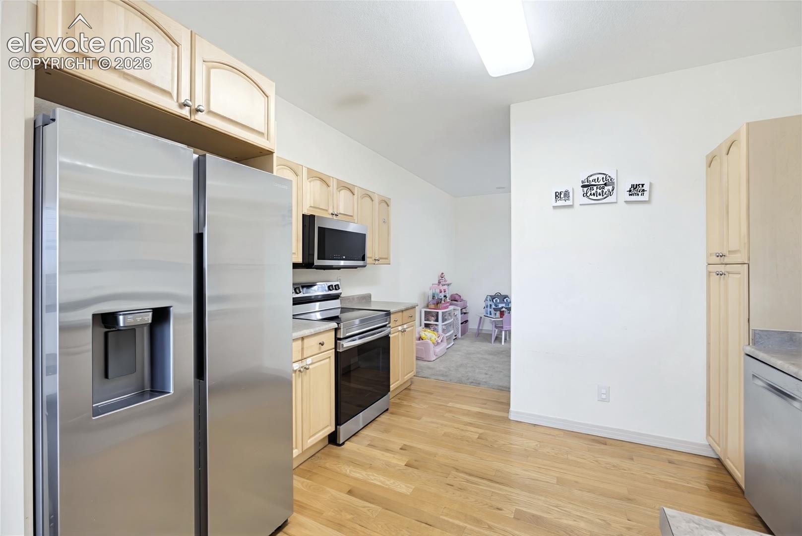 Lower level featuring a built-in bar, tile flooring, carpeted area, and glass sliding doors