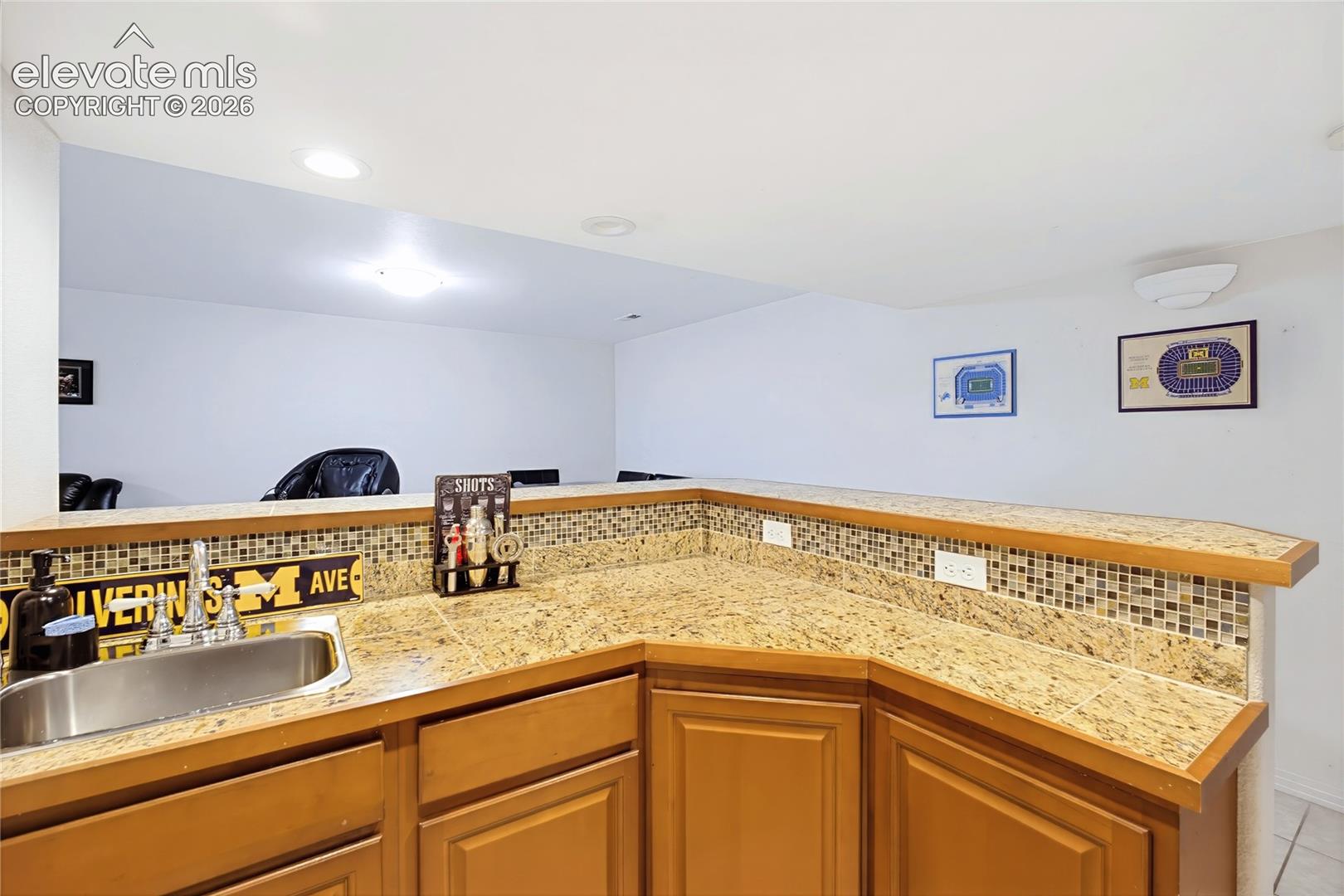 Kitchen featuring wood-finish flooring, stainless steel appliances, and light-toned cabinetry