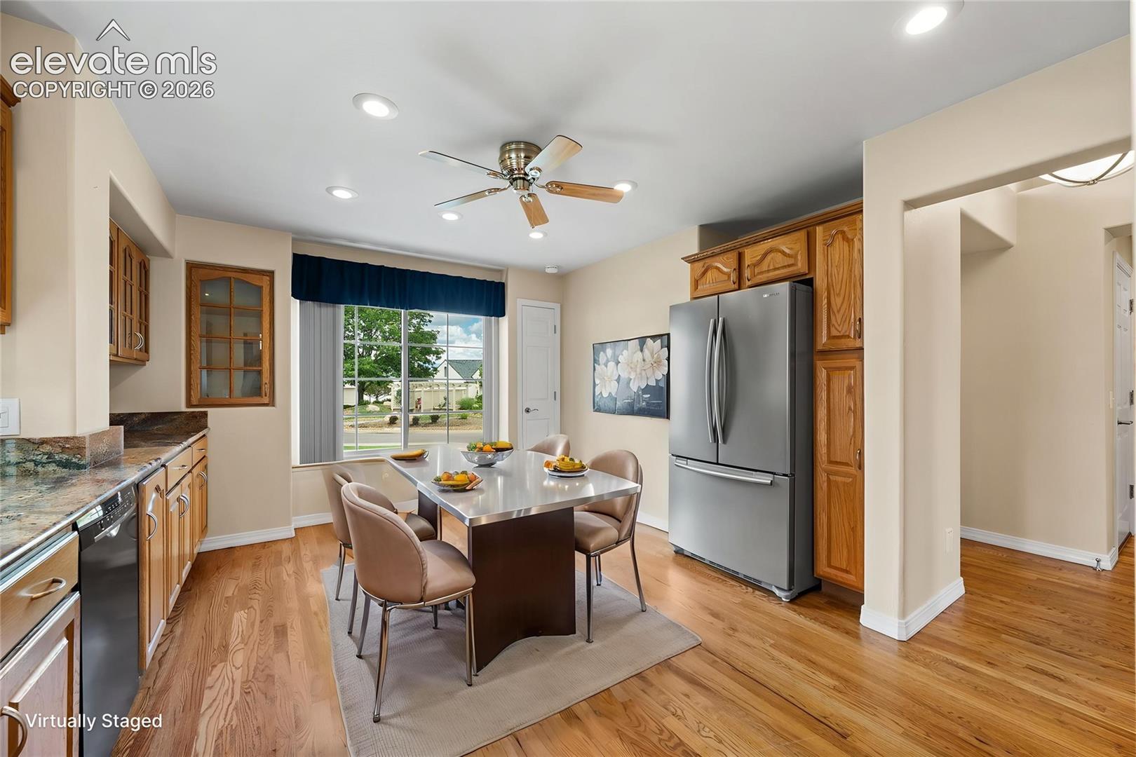 Kitchen featuring wood-finish cabinetry, stone countertops, stainless steel appliances, wood-finish flooring, and recessed lighting