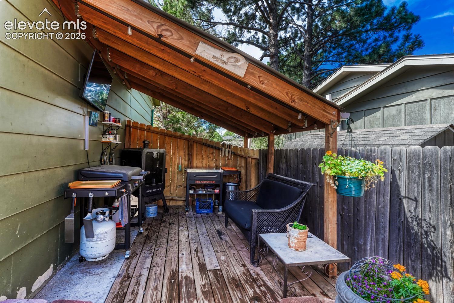 Side covered deck with BBQ area.
