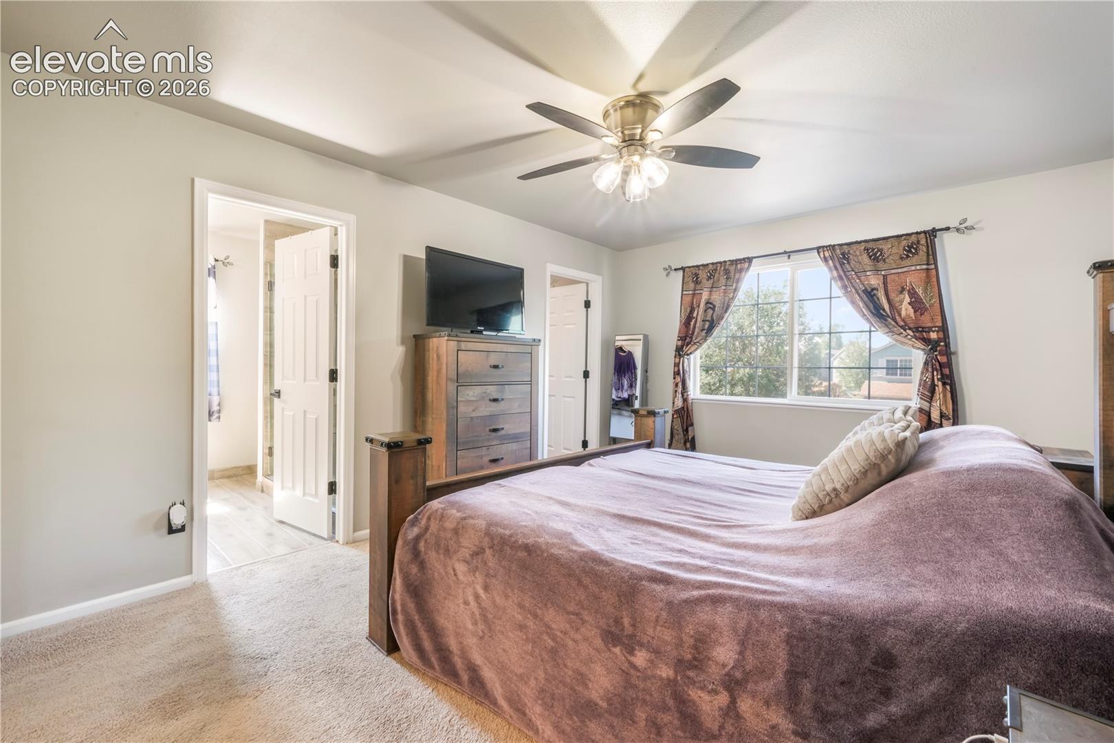 Upstairs Primary bedroom with views of Pikes Peak, 2 closets and updated bathroom