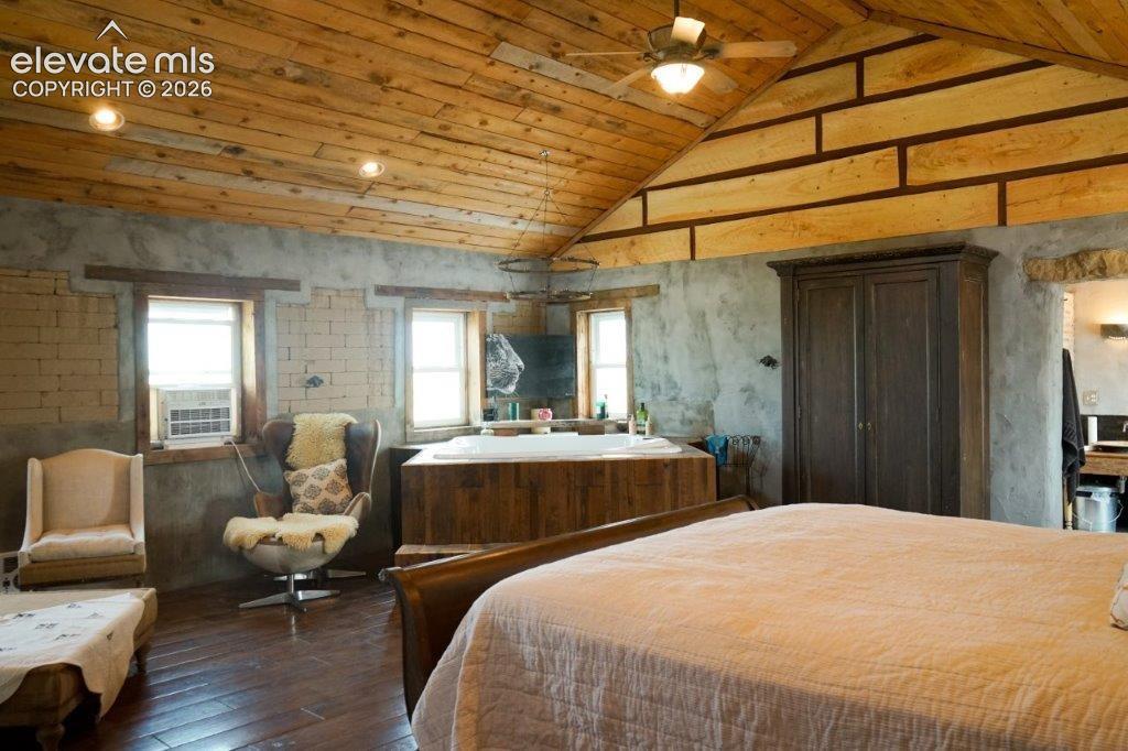 Vaulted wood-plank ceiling with recessed lighting and ceiling fan
