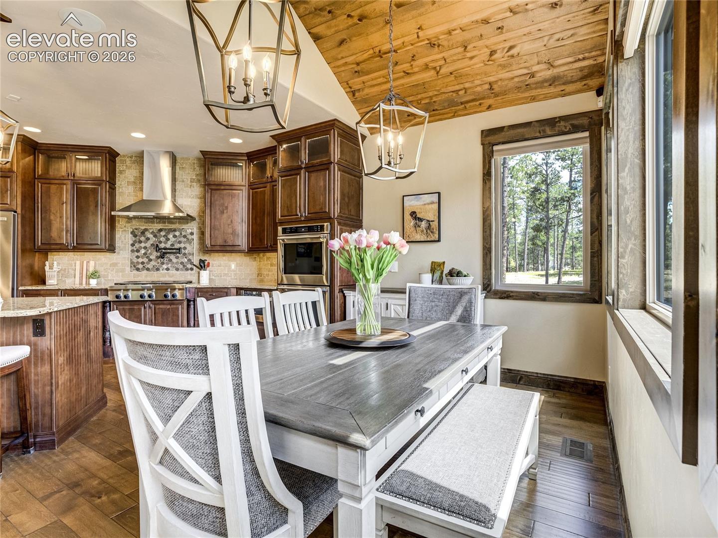 Rustic wood details create an inviting gathering space within the eat-in nook.