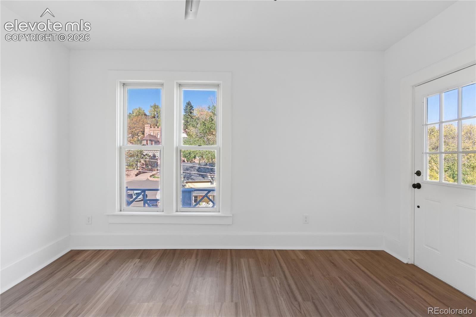 2nd-floor flat primary
bedroom, adjoining
shared bath, door to
balcony