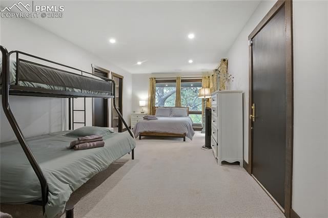 Bedroom featuring light colored carpet and recessed lighting