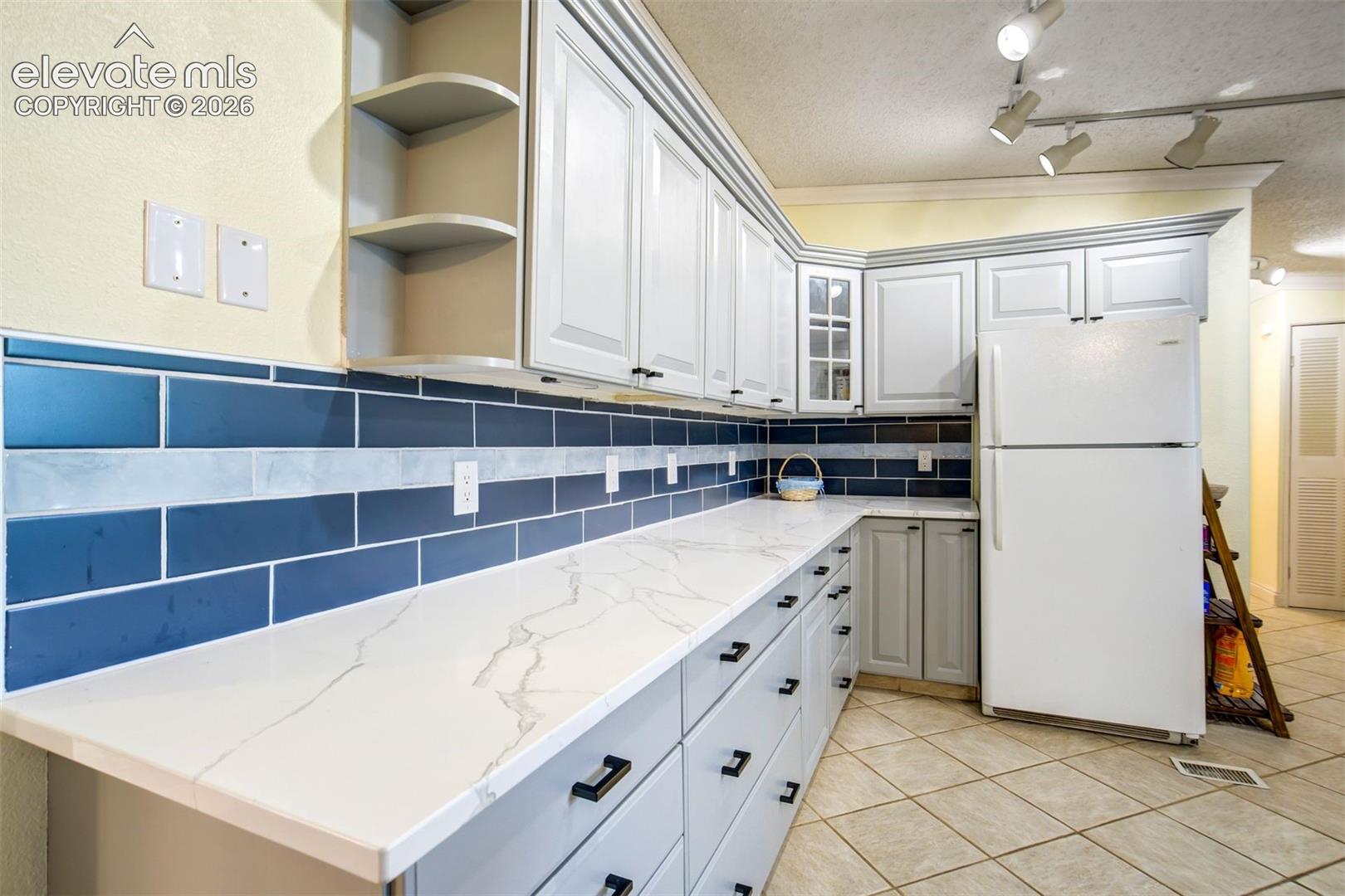 Space featuring quartz countertops.