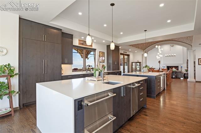 Double waterfall quartz islands, floor-to-ceiling cabinetry, and JennAir appliances blend high performance with timeless design.