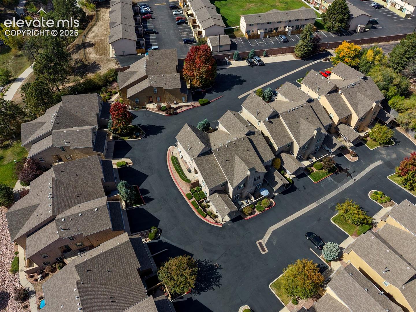 Townhome community featuring multi-story residences, pitched roofs, and landscaped grounds