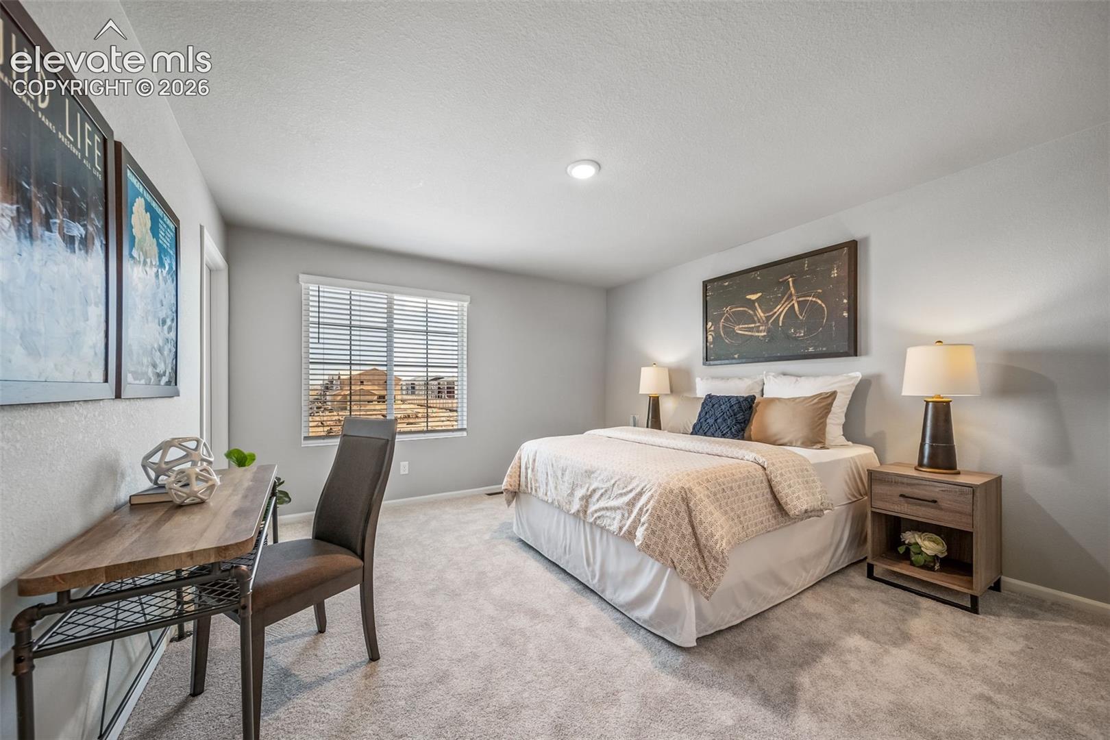 Carpeted room with a vaulted ceiling, recessed lighting, and a large window with blinds
*photos of a model home*