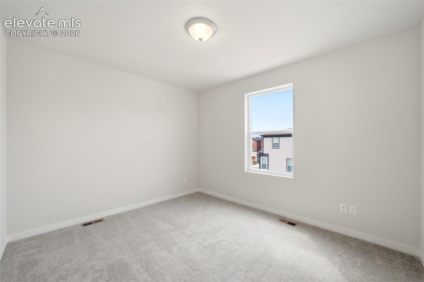 Bedroom -2 Neutral gray walls and light gray carpeting create a versatile interior palette