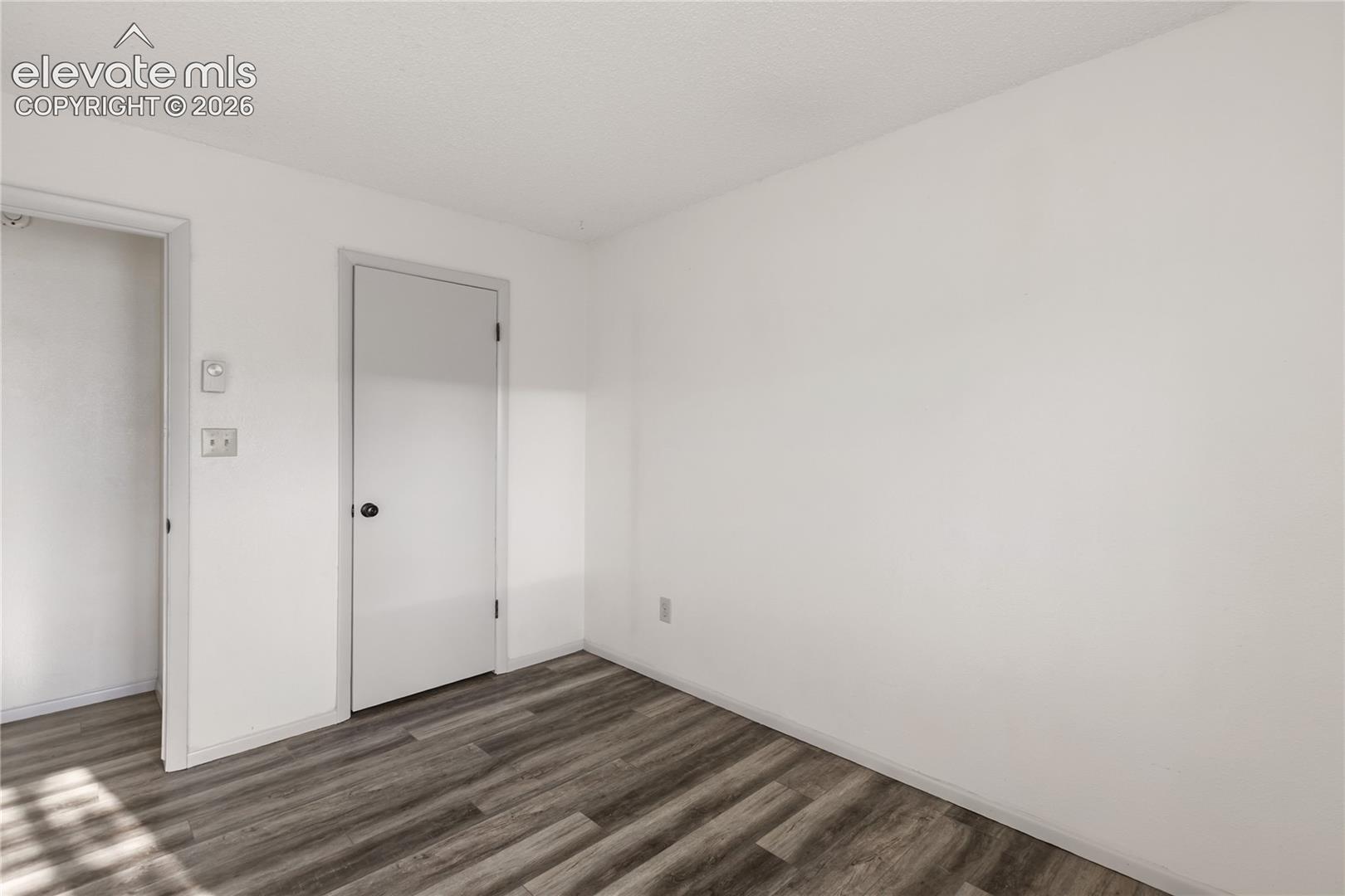 Neutral white walls with wood-finish flooring
