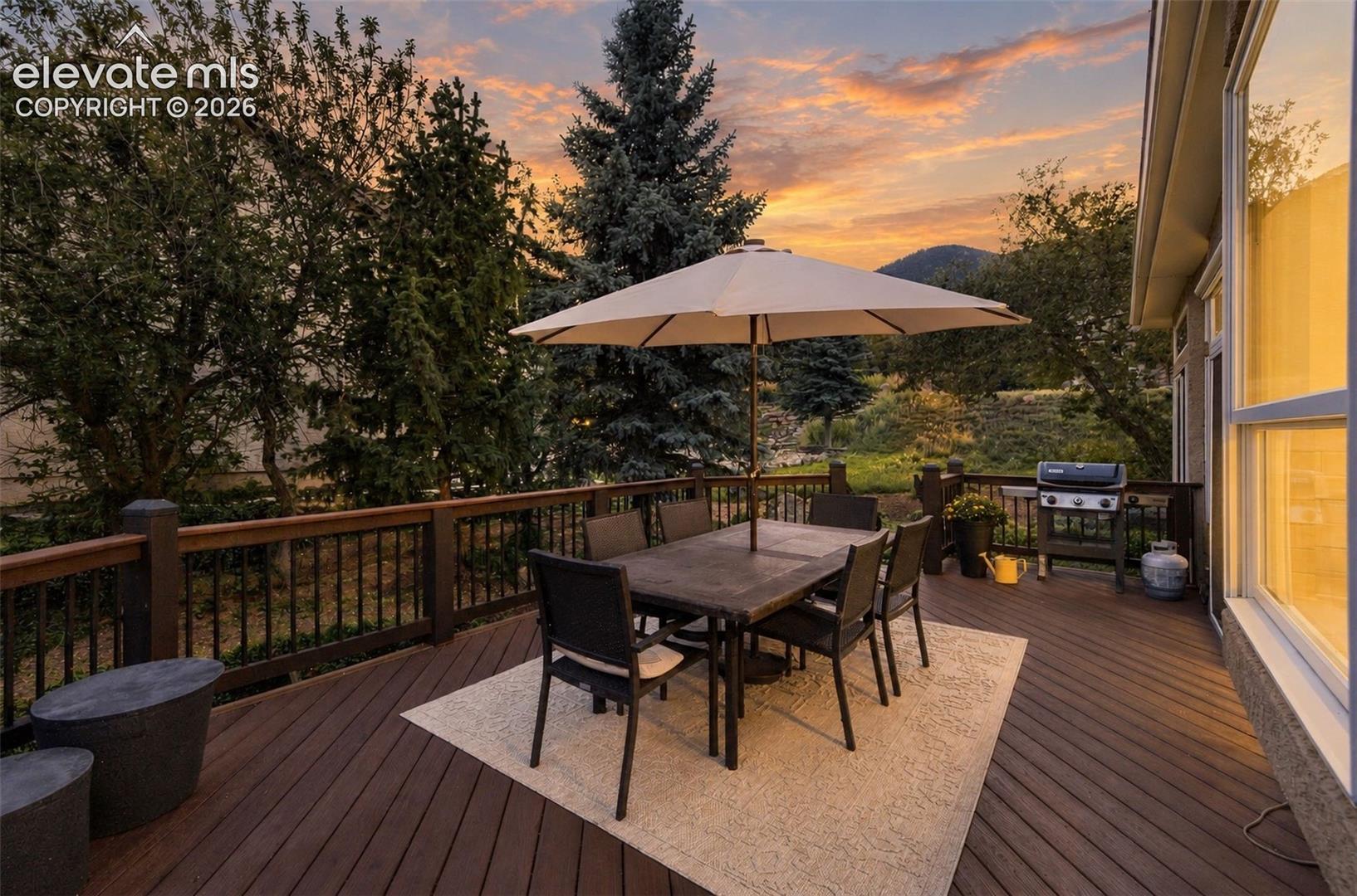 Expansive outdoor deck with composite decking and dark wood railings