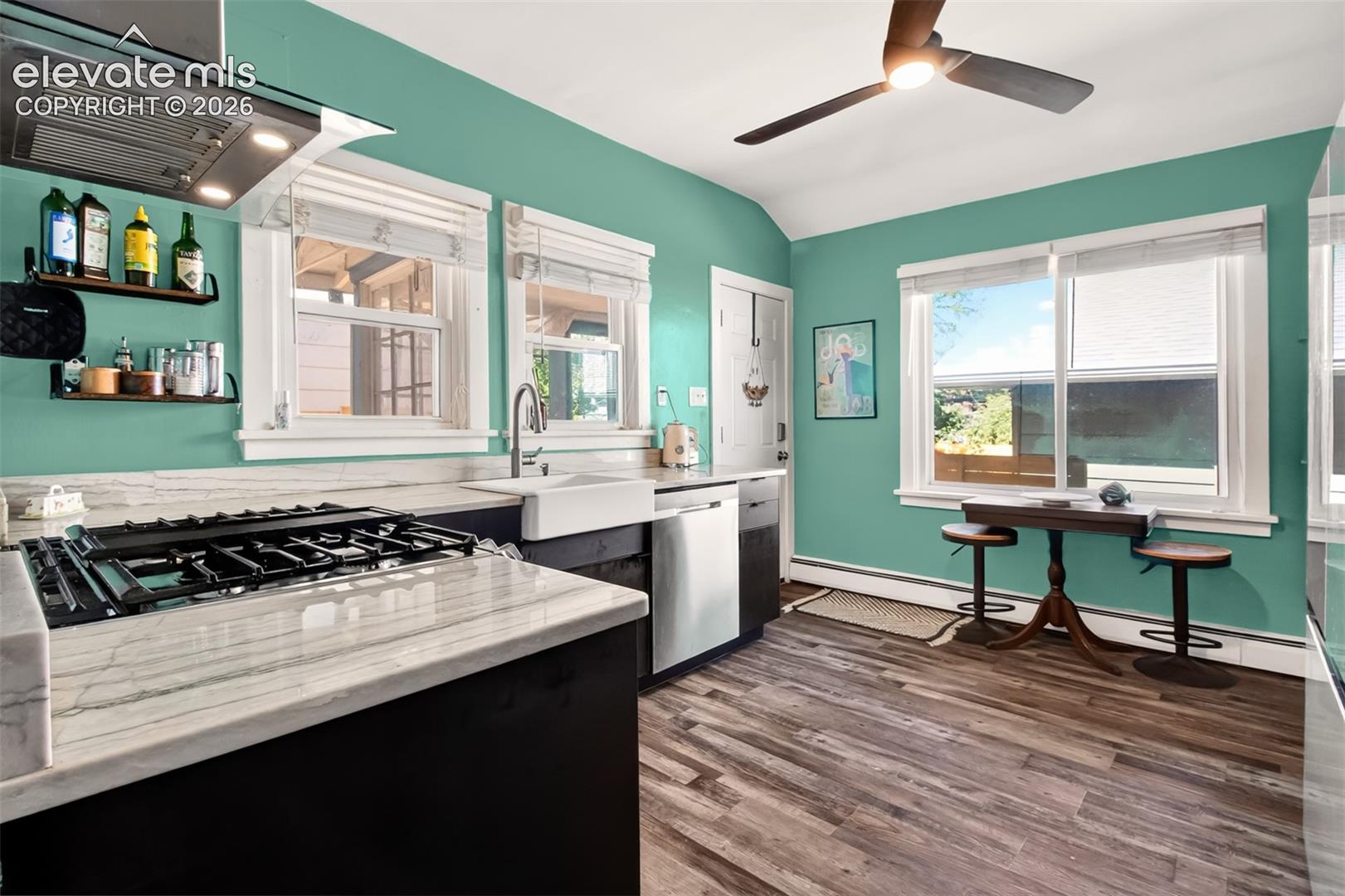 Gorgeous luxury vinyl flooring, farm sink, gas stove