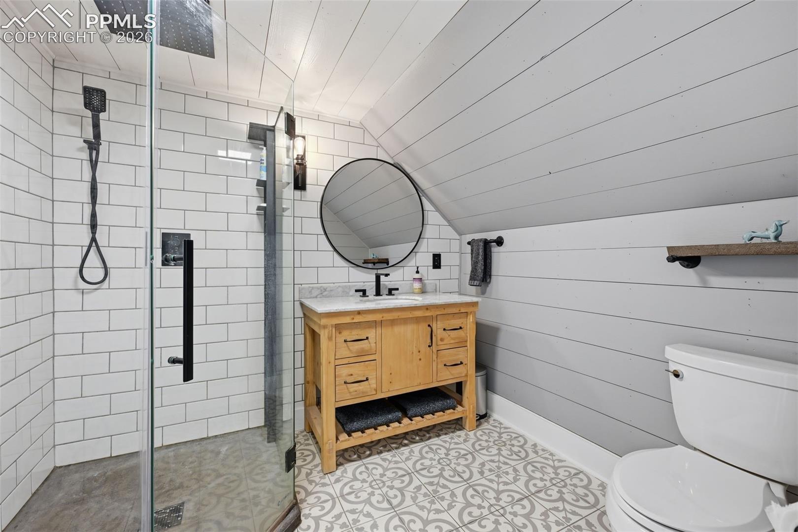 The primary suite offers a 3/4 private bathroom with glass surround shower.