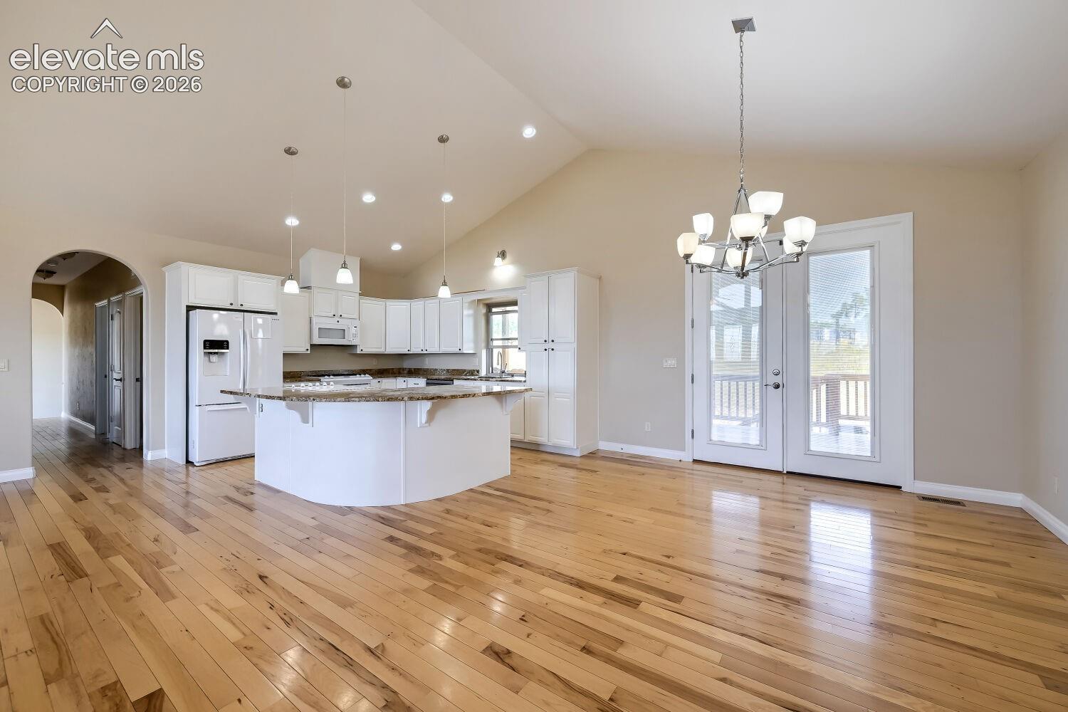 Observe the arch leading you to two additional bedrooms. large laudndry room  and the extra large mudroom and garage. The main floor features 3 bedrooms and an office.