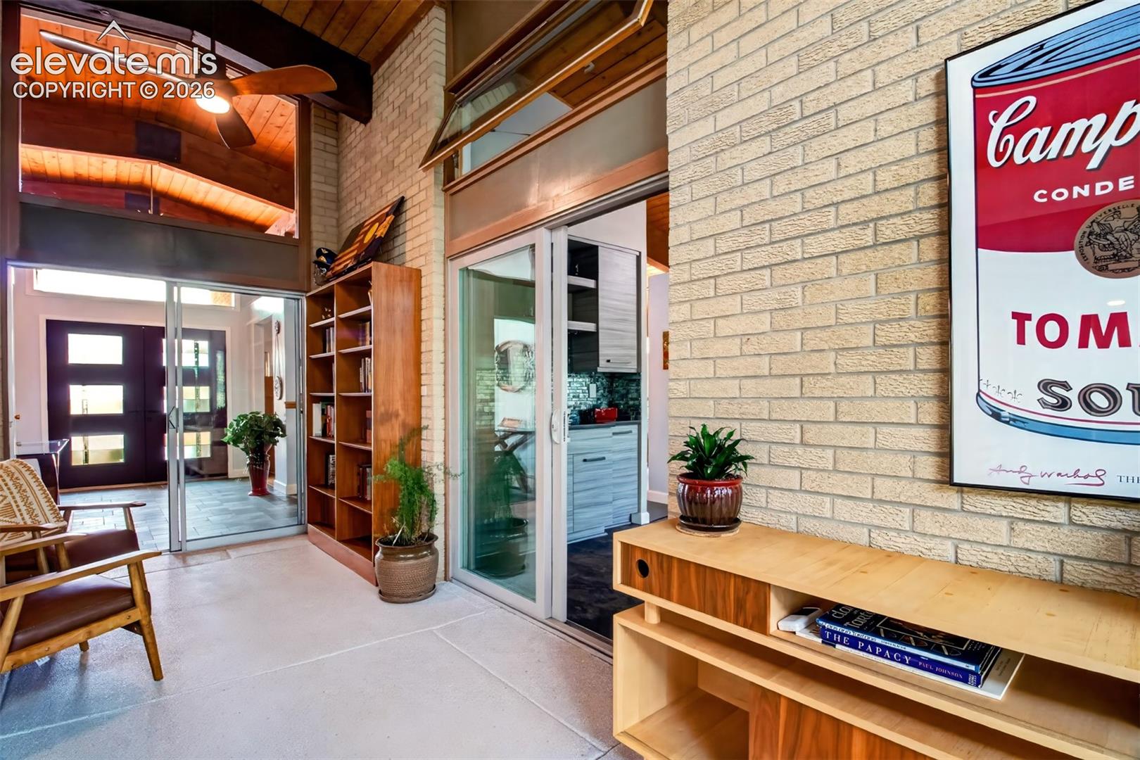 The cozy sun room has epoxy flooring and is a perfect spot to catch an afternoon nap