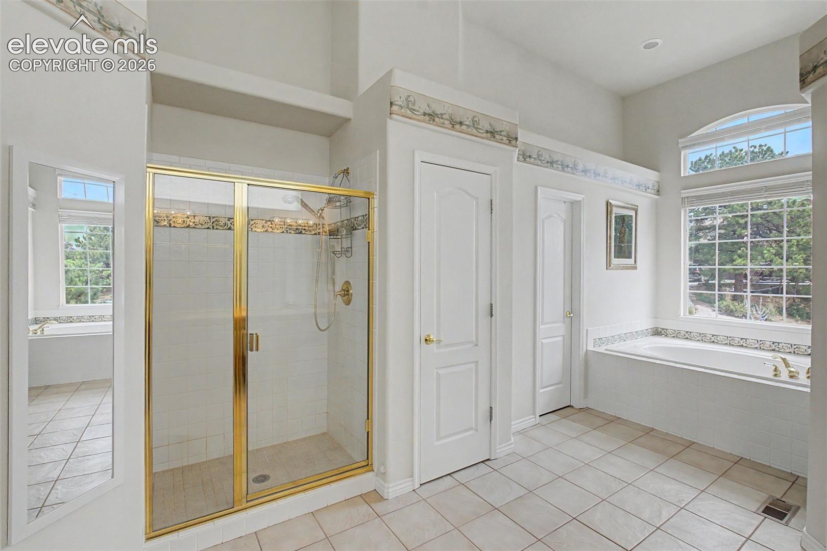Spa Like Primary Bathroom with Dual Walk-in Closets!