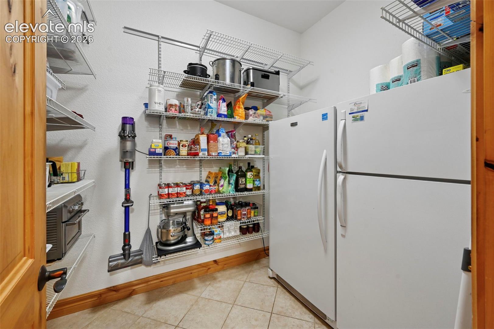 Pantry with full size refrigerator and freezer that conveys with property!