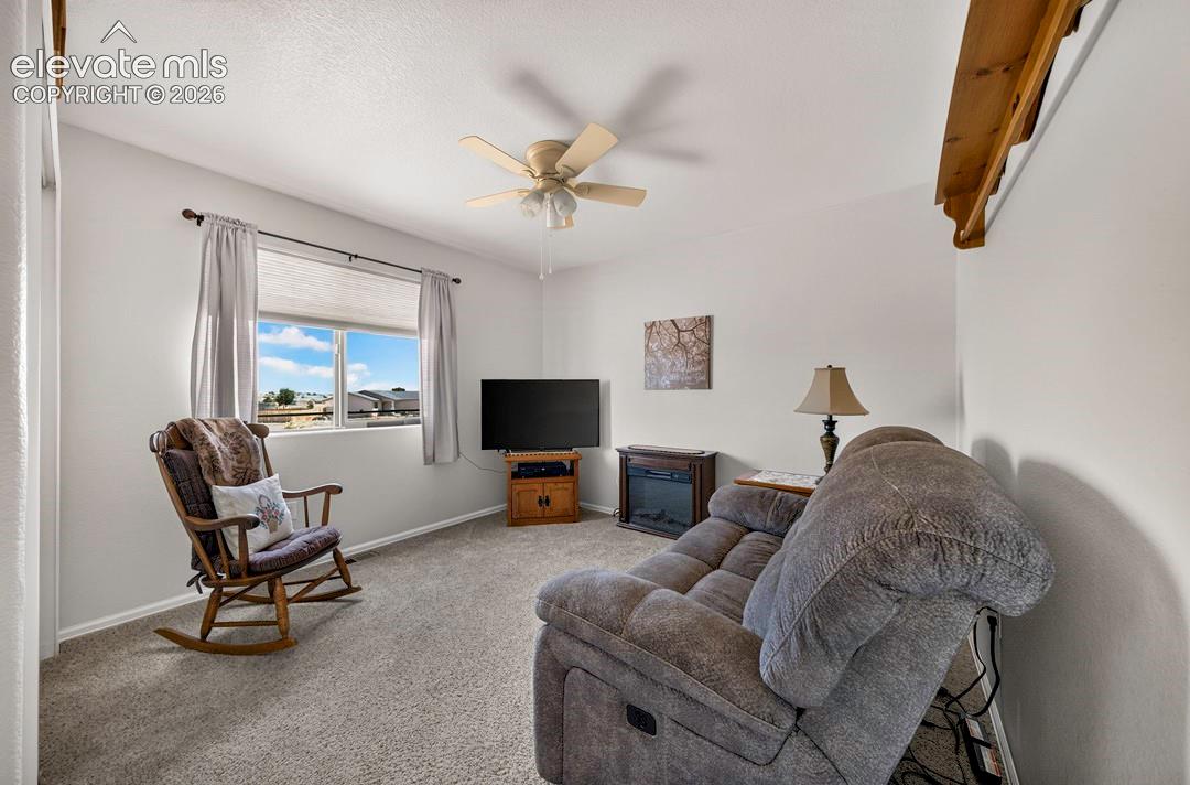 BR #4 a window with cellular shades, a ceiling fan