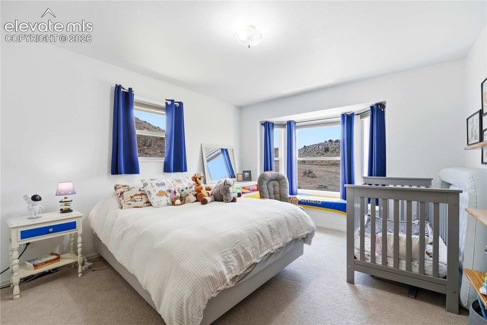 Recessed lighting, wall-to-wall carpeting, and a large bay window