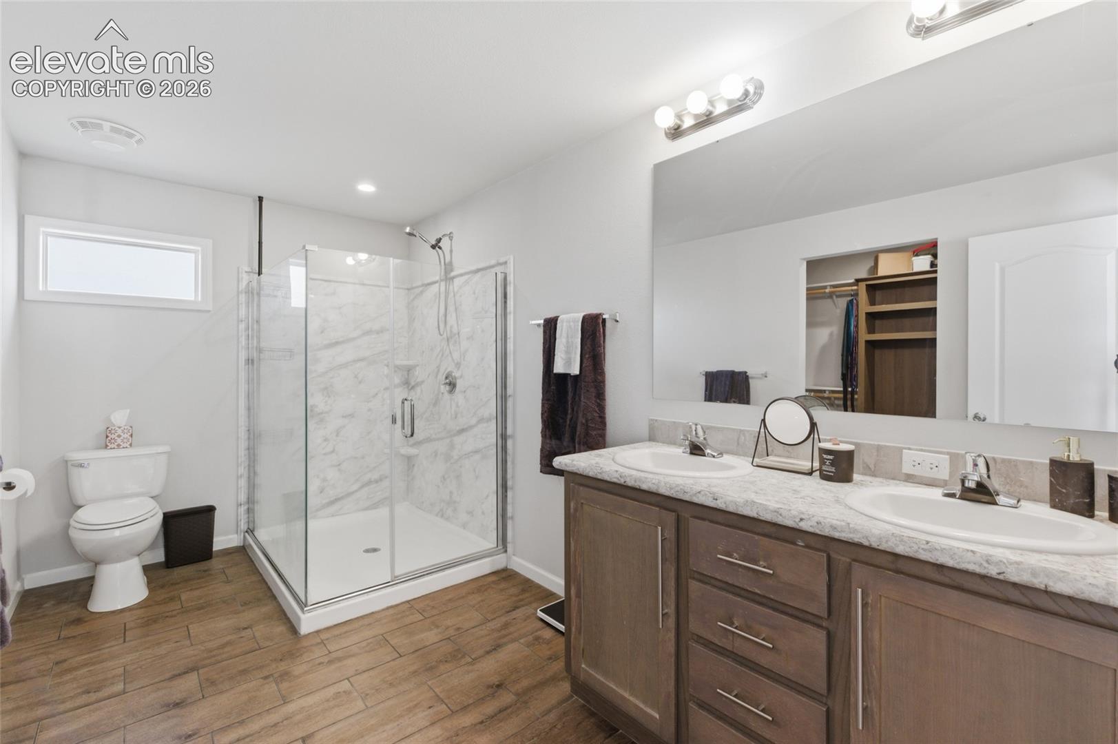 Primary 3/4 bathroom with adjoining walk-in closet