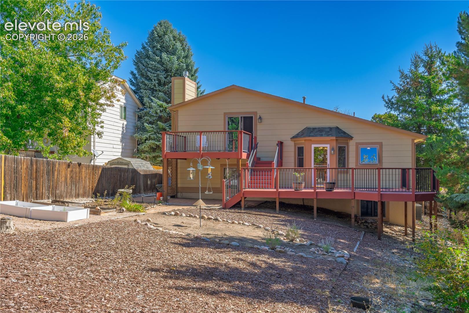 Multi-level exterior deck with dark railings, providing outdoor living space