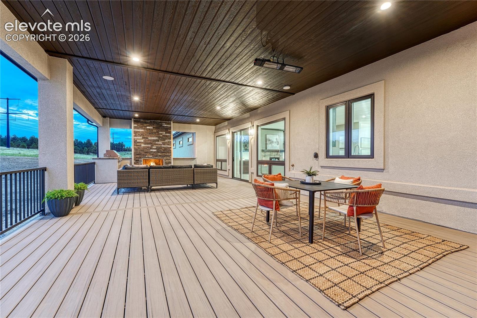 ...ceiling mounted heater and access to primary bedroom and backyard. 