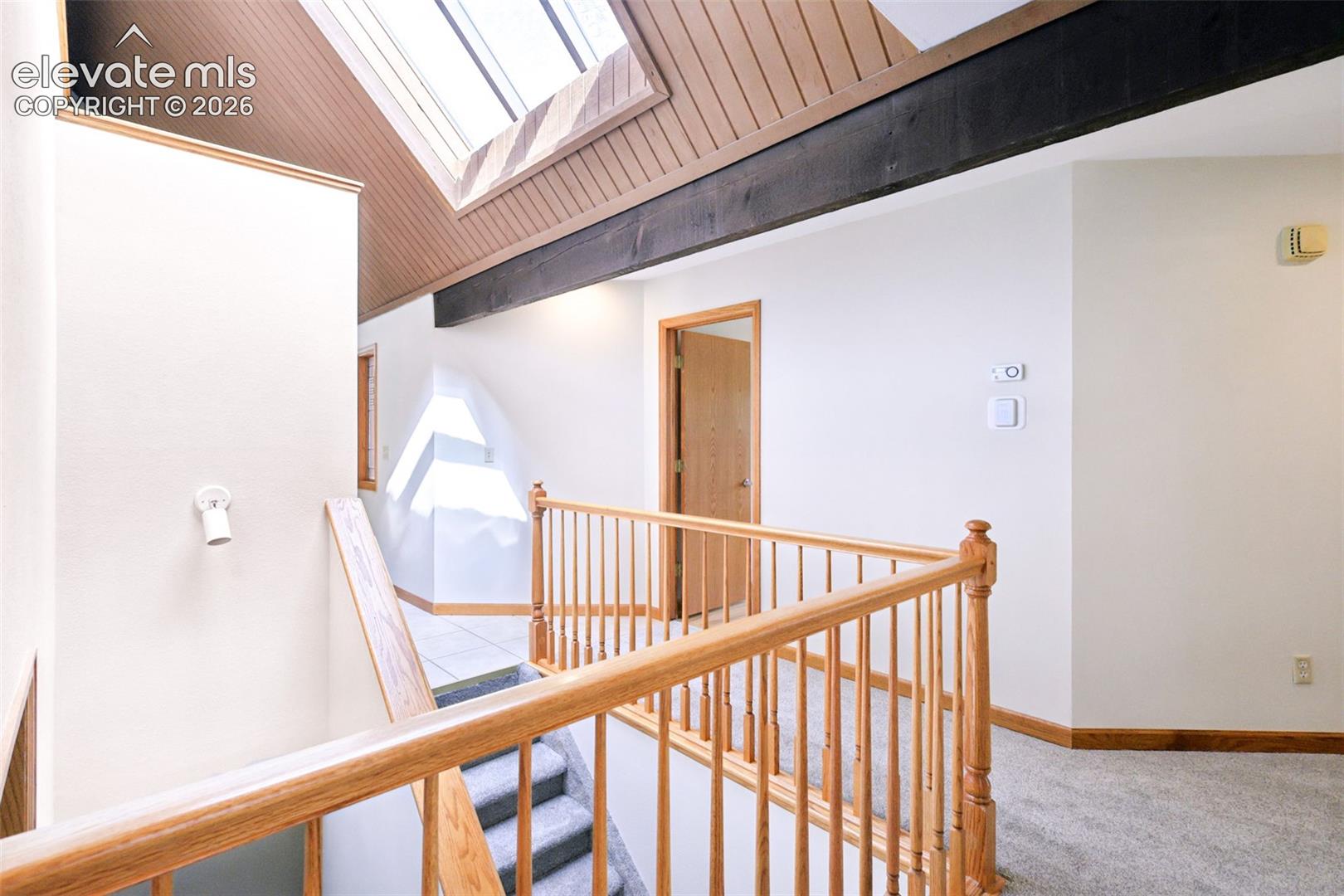 Open hallway to main level bedrooms and office/studio in lower level.  The large windows provide beautiful natural light!