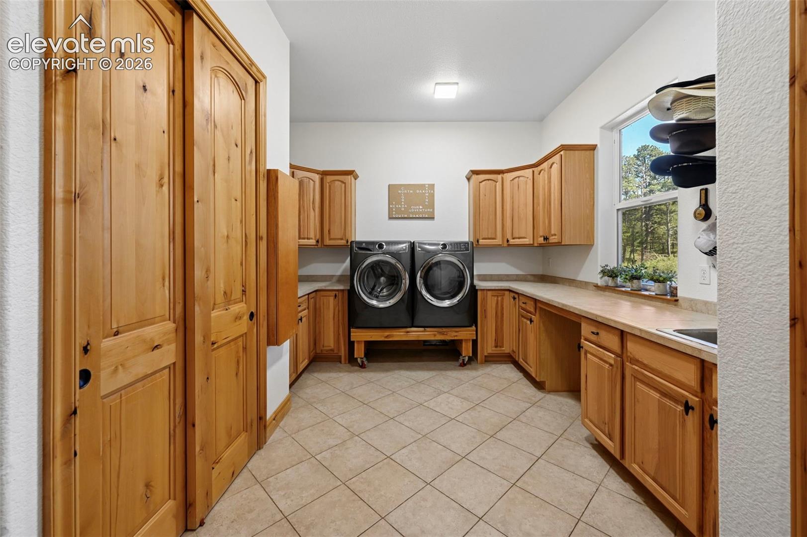 Laundry / Hobby / Organization room with utility sink, closet and built in ironing board. 