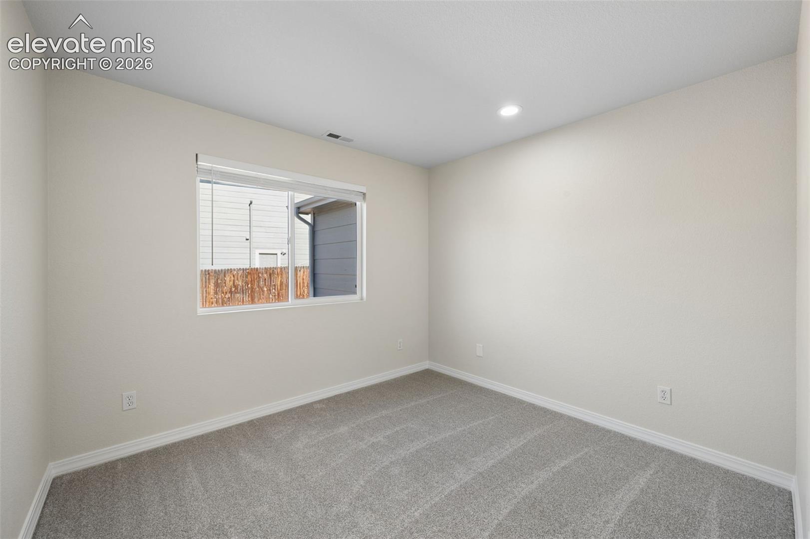 Interior room featuring neutral wall paint, recessed lighting, and wall-to-wall carpeting