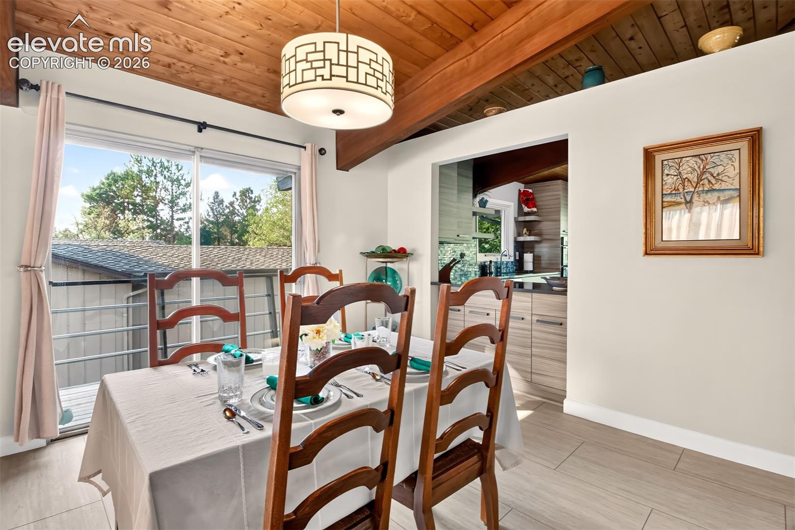A sliding galss door off of the dining room opens to a deck walkway that leads to the patio at the back of the home.