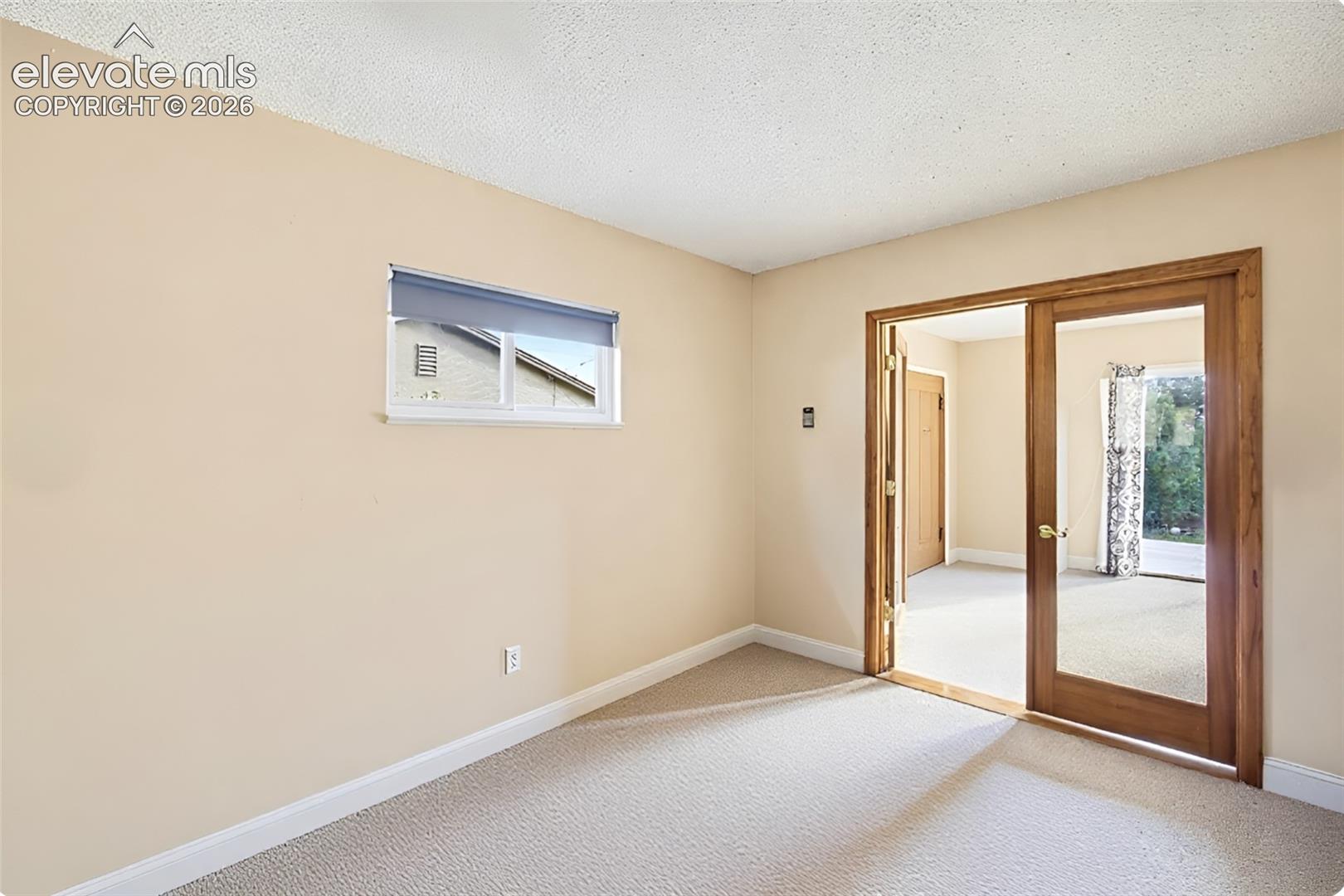 Adjoining living room with walkout and fireplace