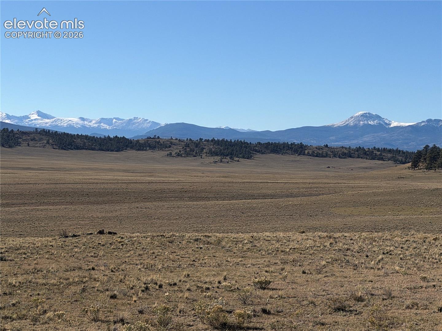 Expansive acreage featuring native high-desert vegetation, rolling topography, and prominent mountain backdrops