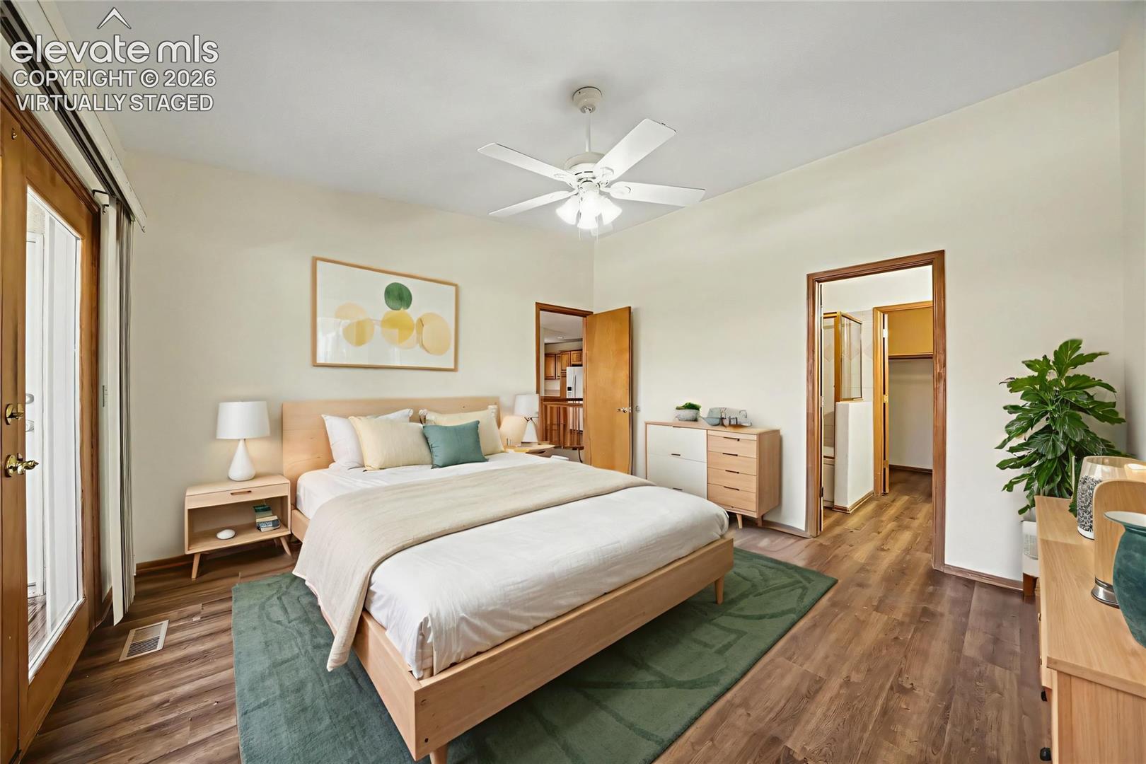 Virtually staged. LVP flooring, ceiling fan, and light-tone walls with walk out to deck