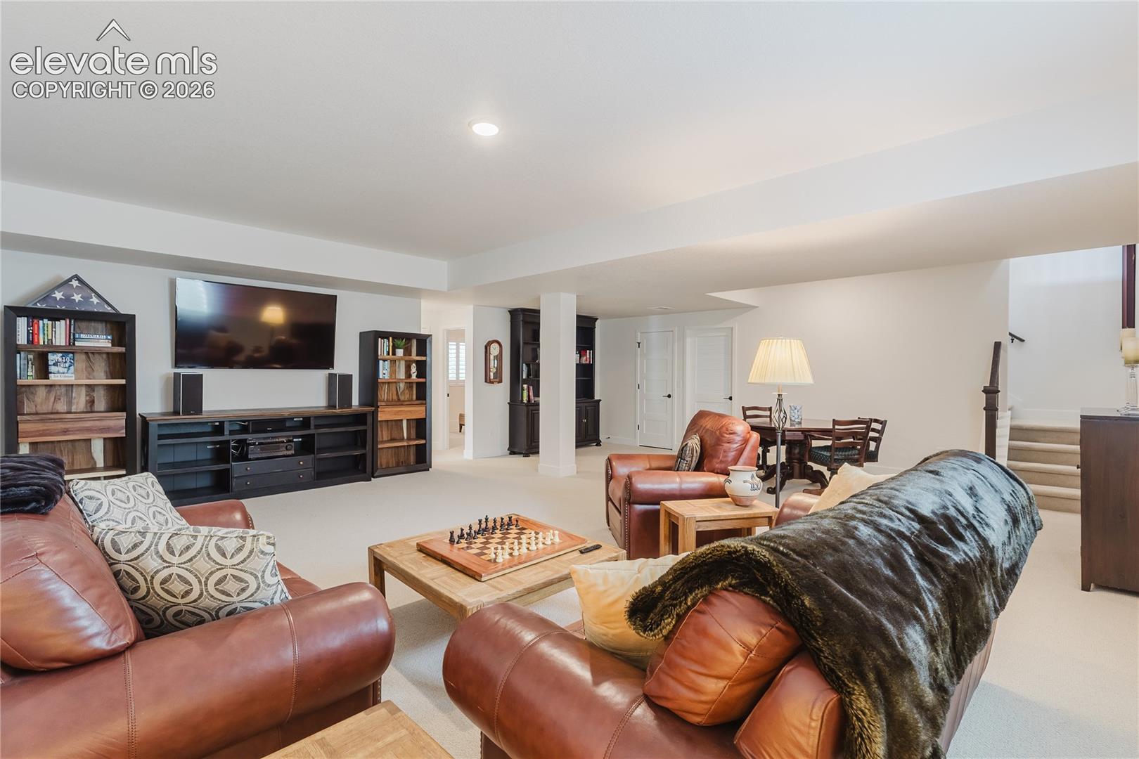 Spacious recreatoin room in the lower level with recessed lighting and carpeted flooring