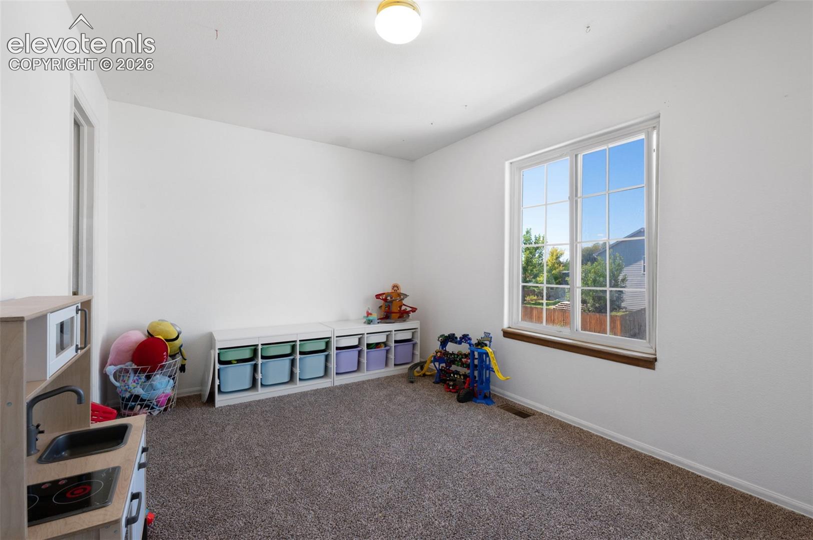 Bright room featuring a large window with white framing and a wood sill