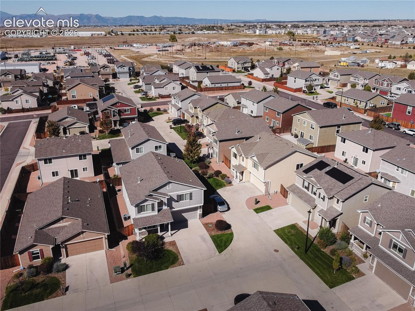 Residential development featuring multiple single-family homes with pitched roofs and attached garages