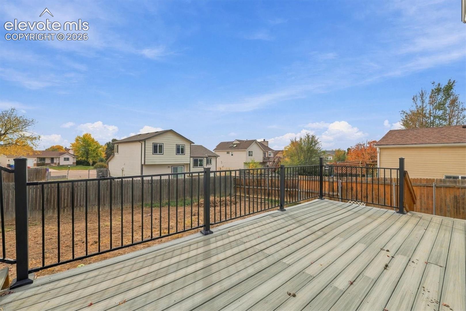 Elevated deck featuring composite decking and black metal railing