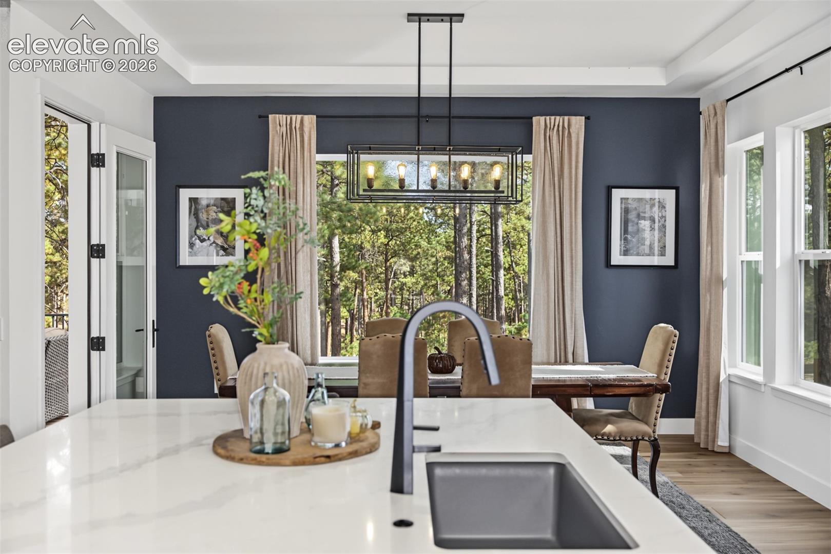 Spacious covered deck overlooking beautiful mature trees, offering a peaceful setting for outdoor entertaining, relaxing, and enjoying the natural surroundings.
