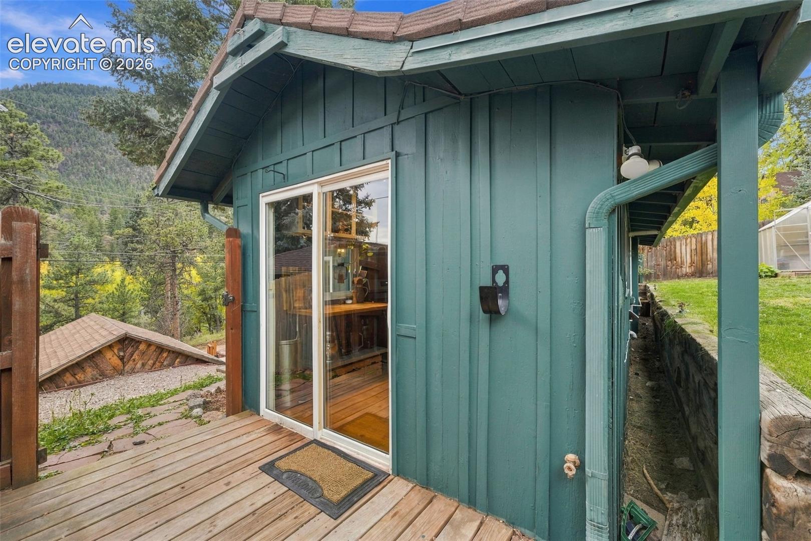 Slider off kitchen with wooden fenced door to detached garage.