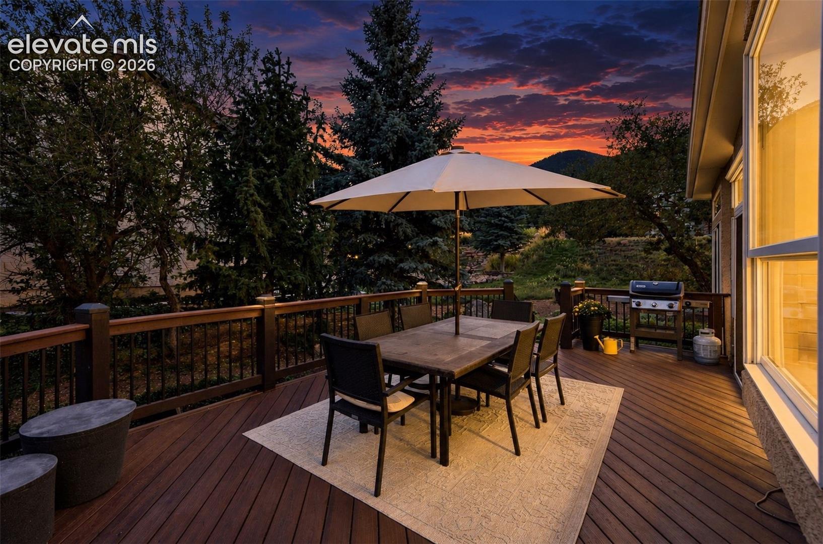 Expansive outdoor deck with composite decking, wood railings, and metal balusters