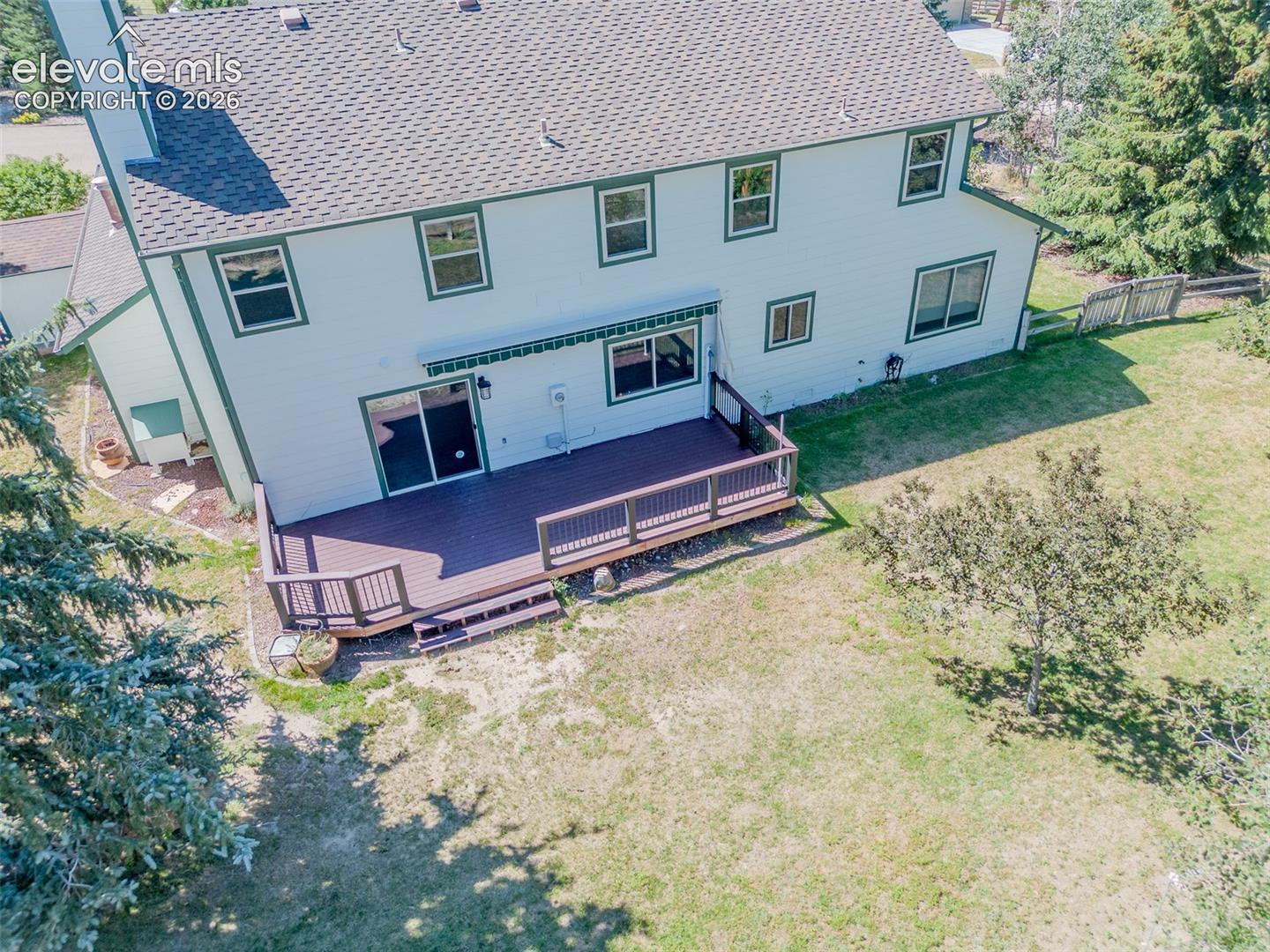 Spacious rear decking with multi-level design and built-in railing