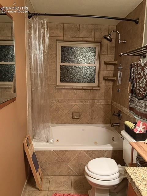 Bathroom featuring a jetted tub, ceramic tile surround, and a frosted window