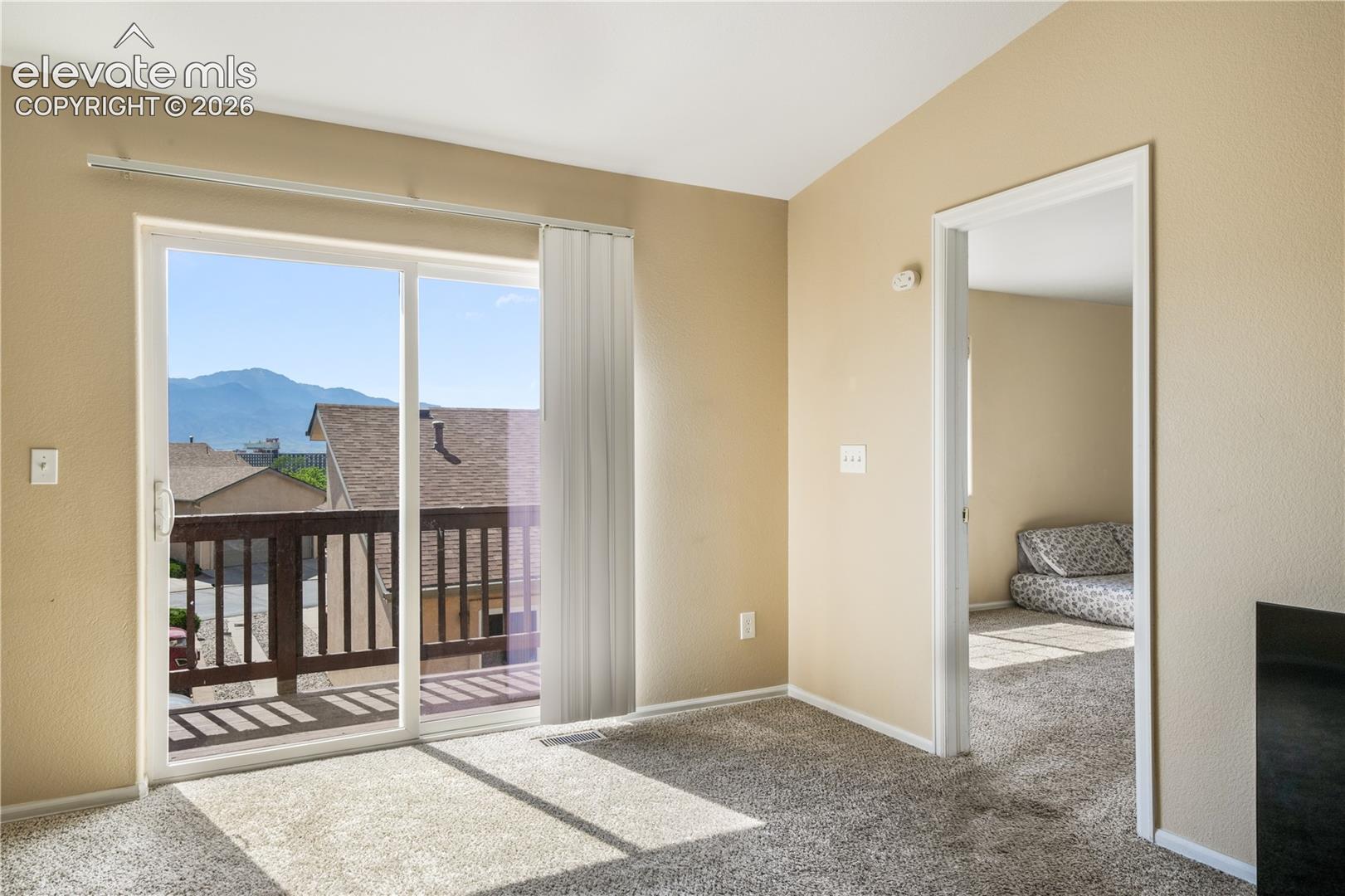 Living room with balcony access and mountain views