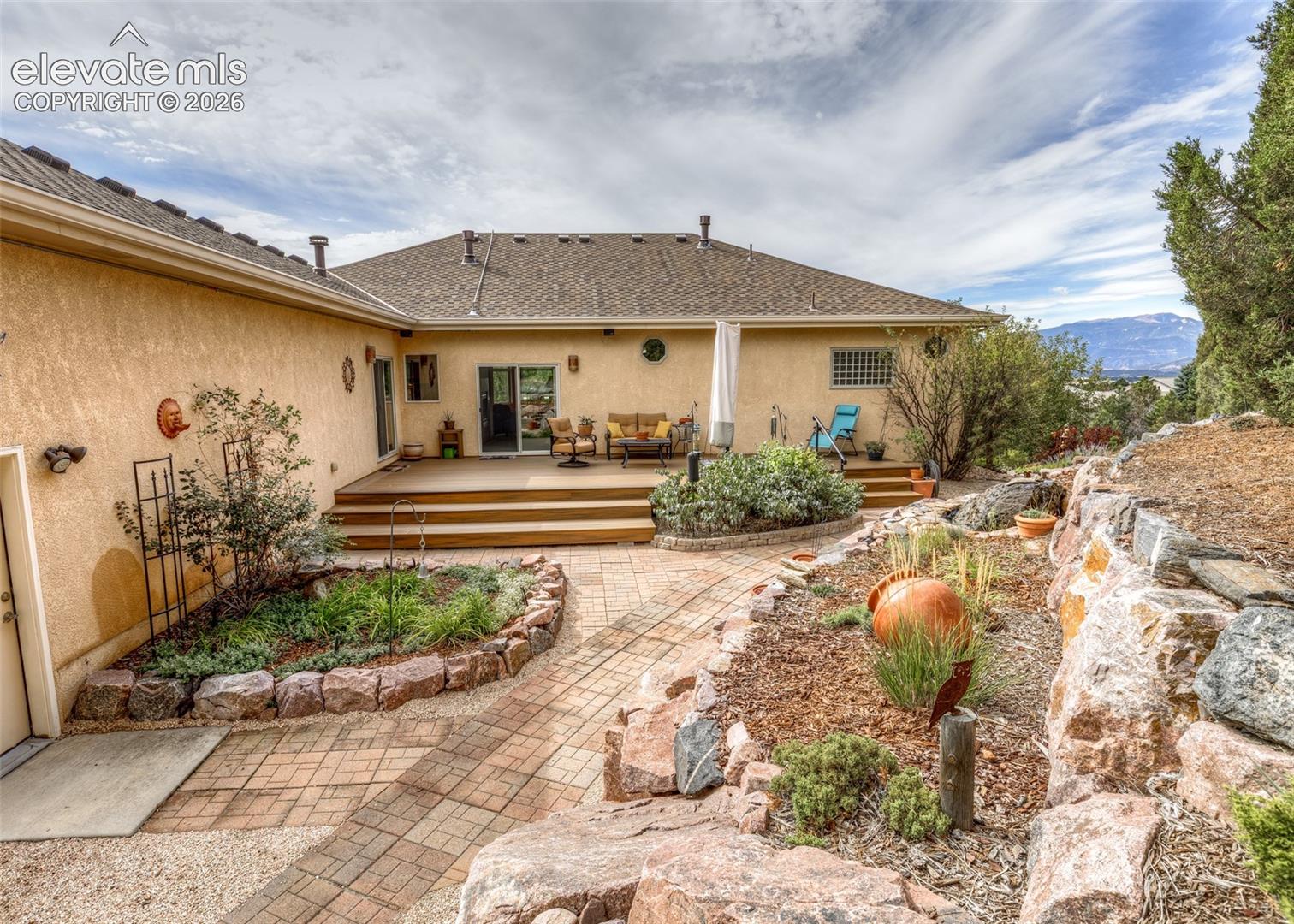 This amazing backyard includes stone retaining walls, stone pathways, seven irrigation zones, a great mix of trees, shrubs and an abundance of beautiful plants and flowers! 