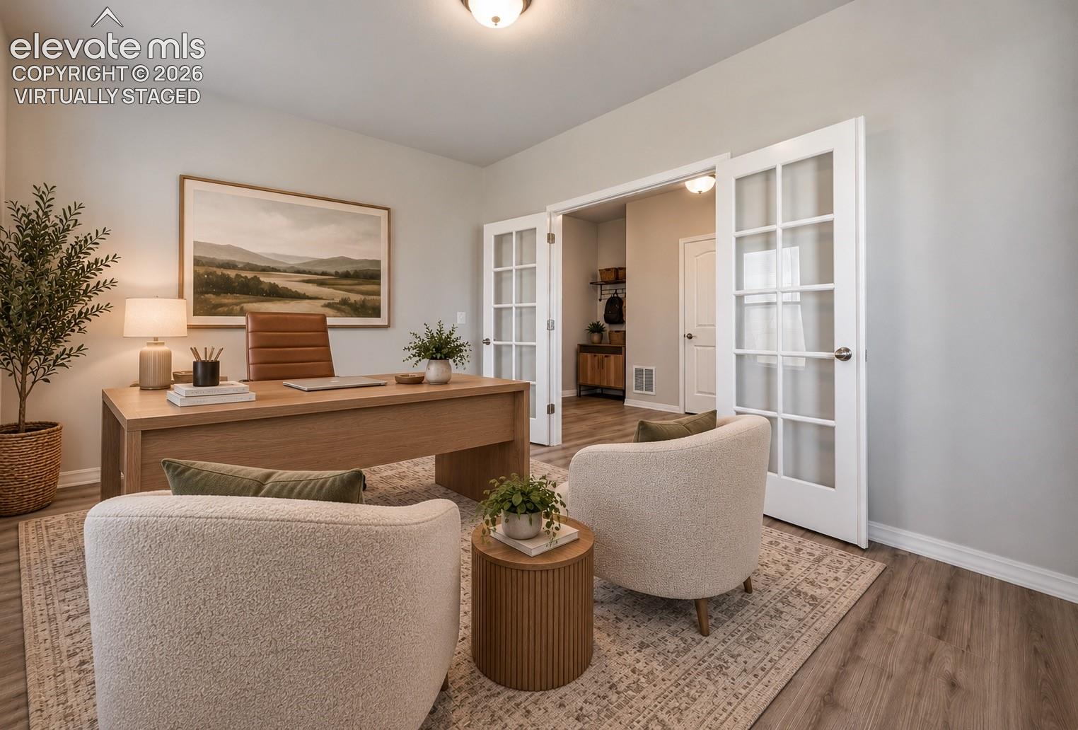 Virtually staged office featuring wood-finish flooring, white French doors with glass panes, and a flush-mount light fixture
