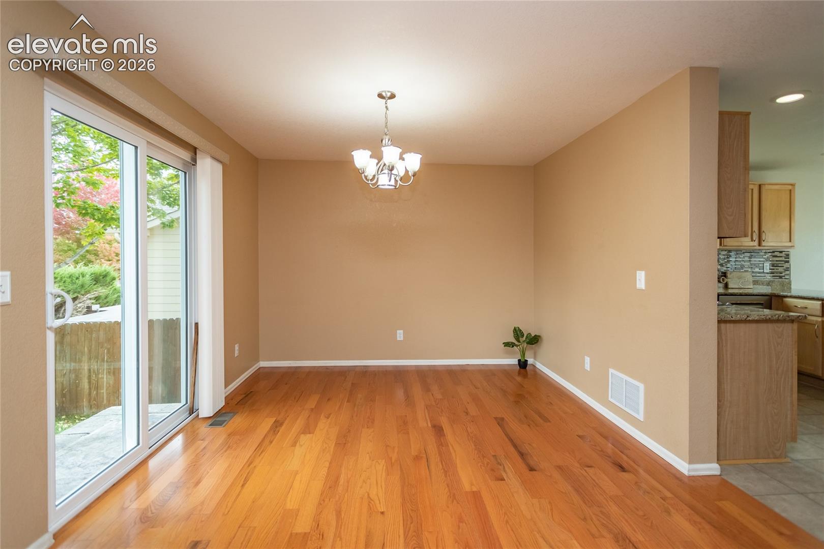 Dining room off the kitchen with sliding door to the backyard