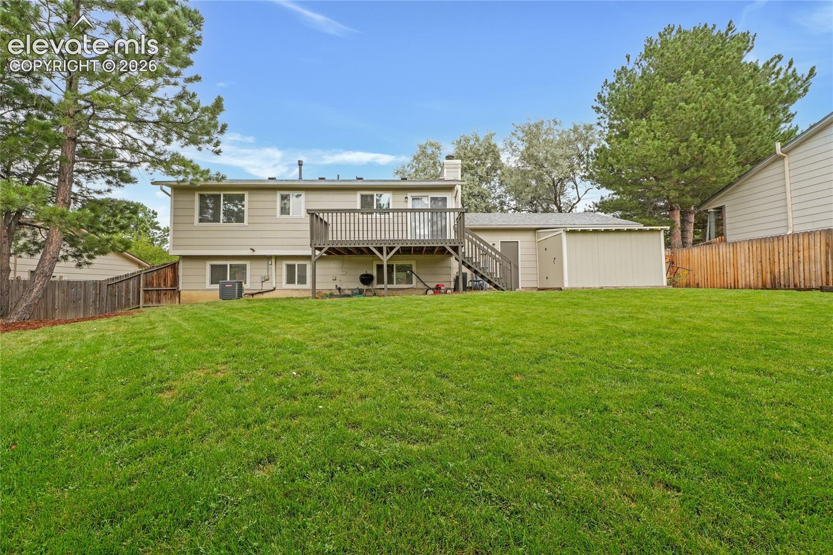 Beautiful fenced in backyard with deck
